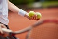 Tennis balls in playerÃ¢â¬â¢s hand Royalty Free Stock Photo